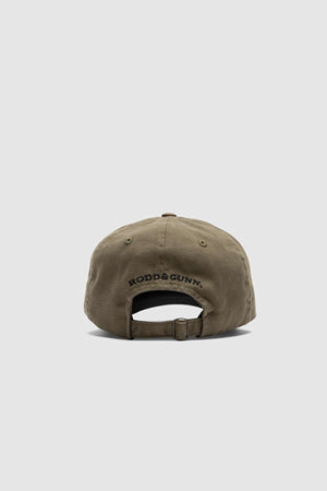 The Rodd & Gunn Gunn Cap is made from heavy duty khaki green cotton twill, featuring "RODD & GUNN" embroidered in black above the adjustable strap and metal clasp.