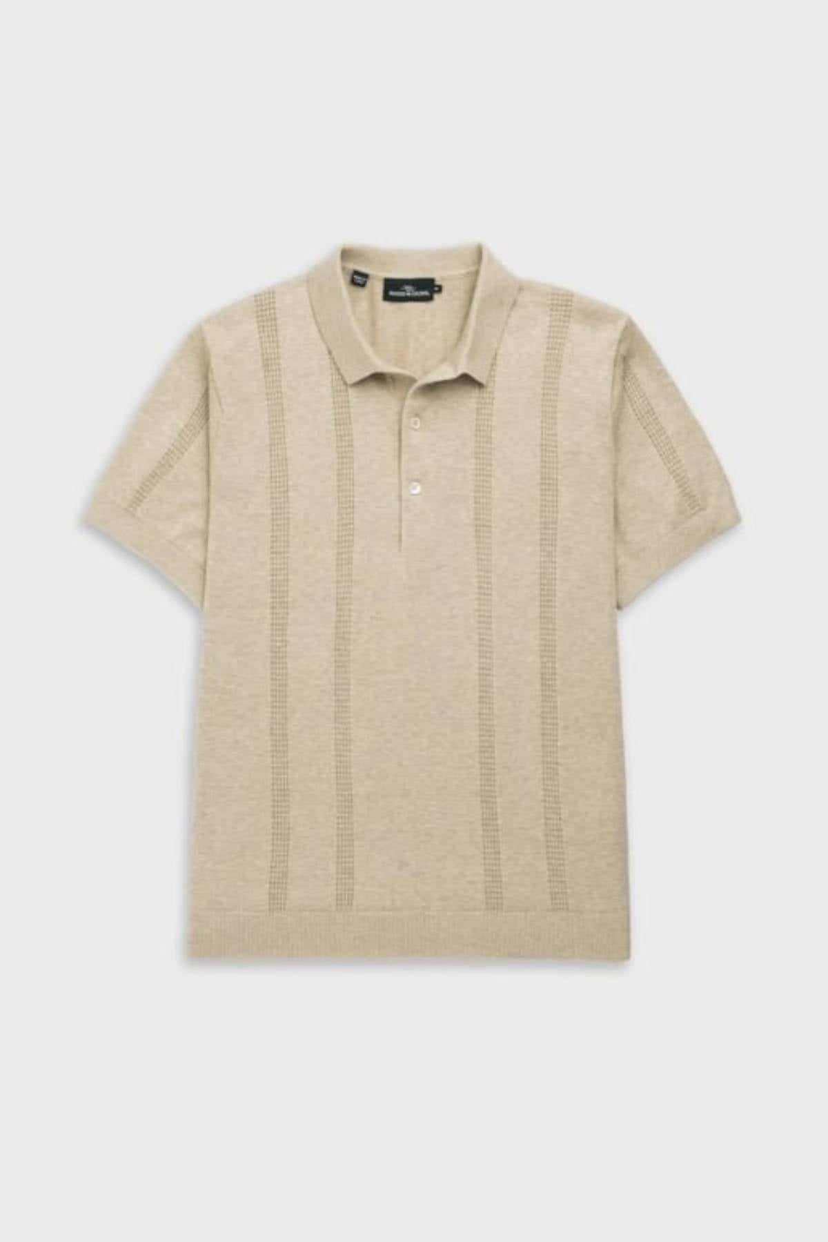 The Rodd & Gunn Brooklands Knit is a beige short-sleeve polo shirt crafted from soft Australian cotton, featuring a collar, three buttons, and subtle vertical textured stripes on the front, shown laid flat on a light background.