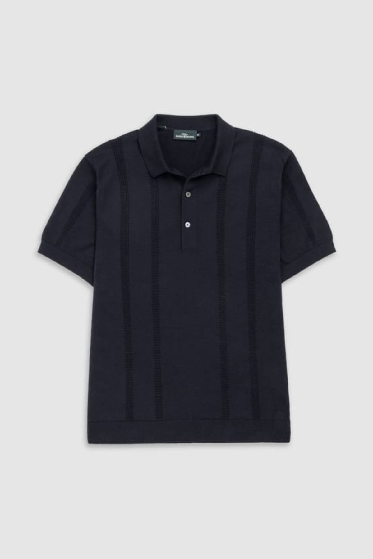 The Rodd & Gunn Brooklands Knit is a short-sleeved, dark navy polo crafted from premium Australian cotton, featuring a collar, two-button placket, and subtle vertical textured stripes, shown on a plain light gray background.