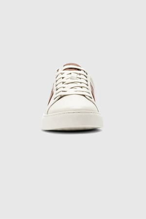 A front view of the Rodd & Gunn Endeavour Cruise Sneaker, featuring white leather, beige laces, and a brown side accent, shown against a plain light gray background.