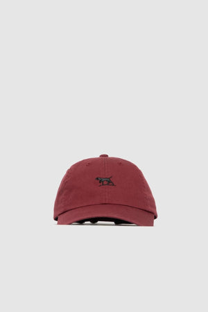 The Rodd & Gunn Gunn Cap is a maroon cotton twill cap featuring a small black pointer dog logo embroidered on the front, shown against a plain light gray background.