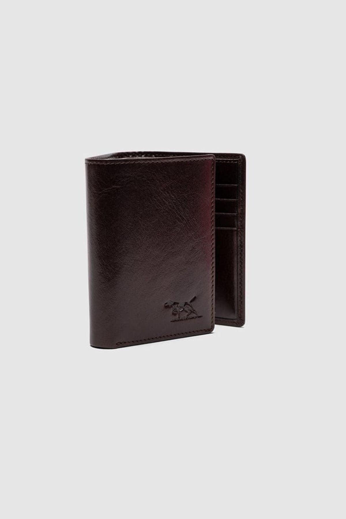 The Rodd & Gunn Westport Tri Fold Wallet, crafted from dark brown Italian leather, is partially open to show multiple card slots. A small embossed logo decorates the front. The wallet is set against a plain light gray background.
