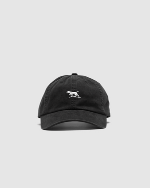 The Rodd & Gunn Gunn Cap, made from heavy-duty cotton twill, sports a black design with a white embroidered two-dog logo on the front. It includes an adjustable strap for a comfortable fit and is showcased on a plain light gray background.