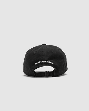 The image displays the Rodd & Gunn Gunn Cap, a black heavy-duty cotton twill cap with an adjustable strap and "RODD & GUNN" embroidered in white above the opening. It's set against a plain light gray background.