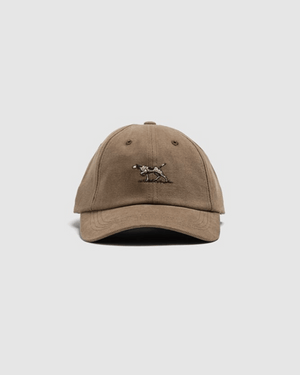 The Rodd & Gunn Signature Cap is a brown cotton twill hat with a small embroidered dog on the front, shown against a plain light gray background.