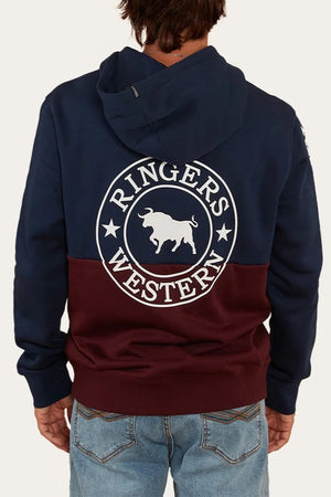 A person facing away from the camera wears a navy and maroon Ringers Western Hahndorf Hoodie with a bull graphic and logo on the back, plus a kangaroo pocket, paired with light blue jeans.