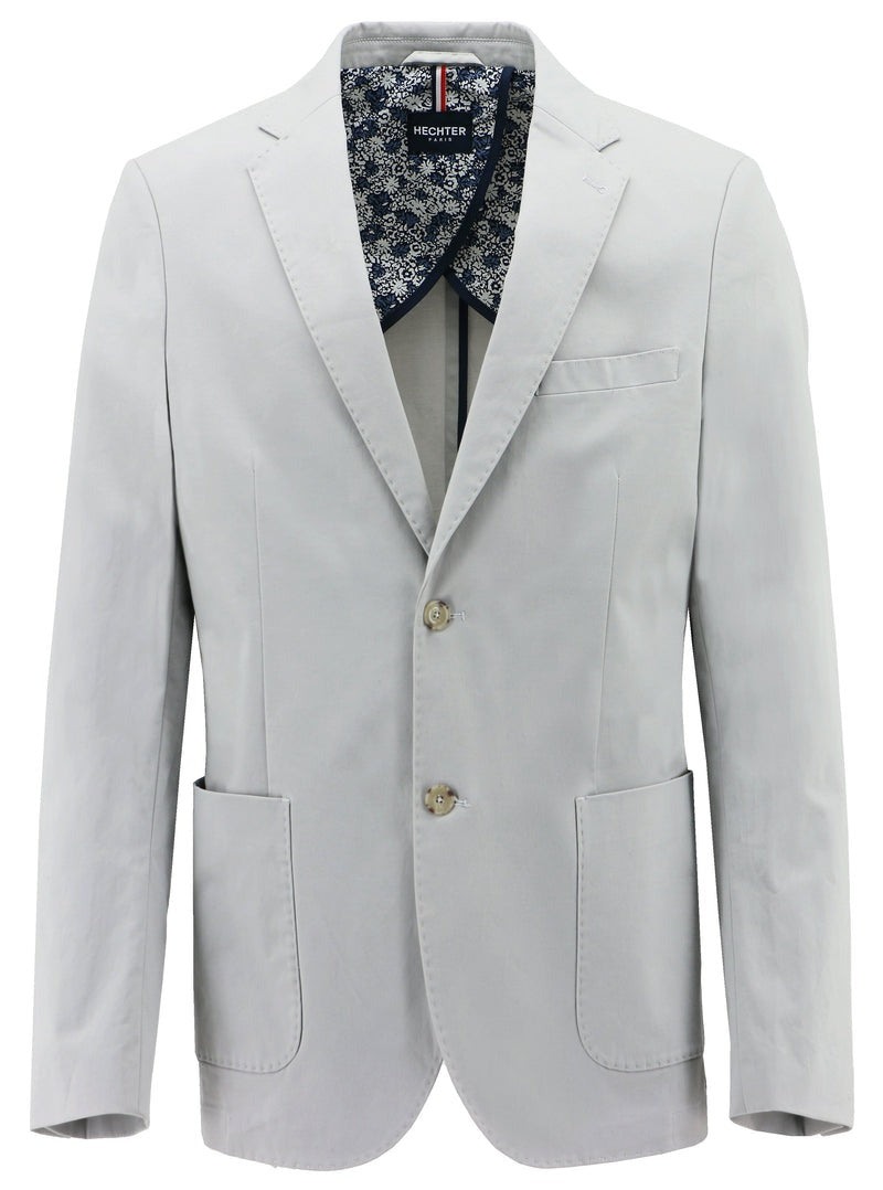 The Hechter Genoa Sports Jacket is a light gray blazer featuring two buttons, notched lapels, and two front pockets. Displayed on a white background, it showcases a simple yet elegant design with a dark blue and white floral patterned lining visible at the collar.