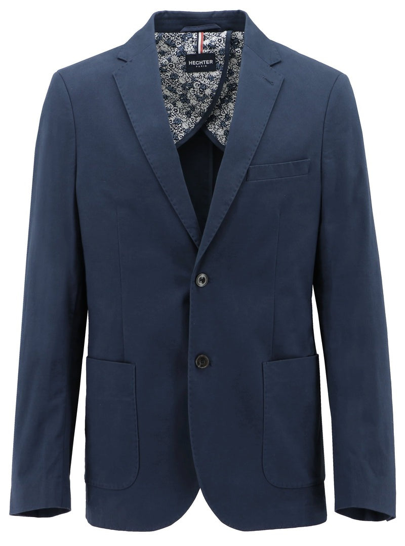 The Hechter Genoa Sports Jacket is a navy blue blazer with a notch lapel, two front buttons, two large front pockets, and a chest pocket. The lining features a white and blue floral pattern. This slim-fit jacket sports a label inside the collar indicating the brand "Merc London.