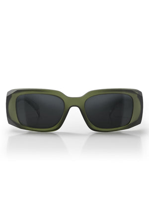 Front view of SafeStyle Auras sunglasses with a matte moss green frame and grey polarised lenses, AS/NZS 1337.1 compliant, resting on a white surface with a subtle reflection below.