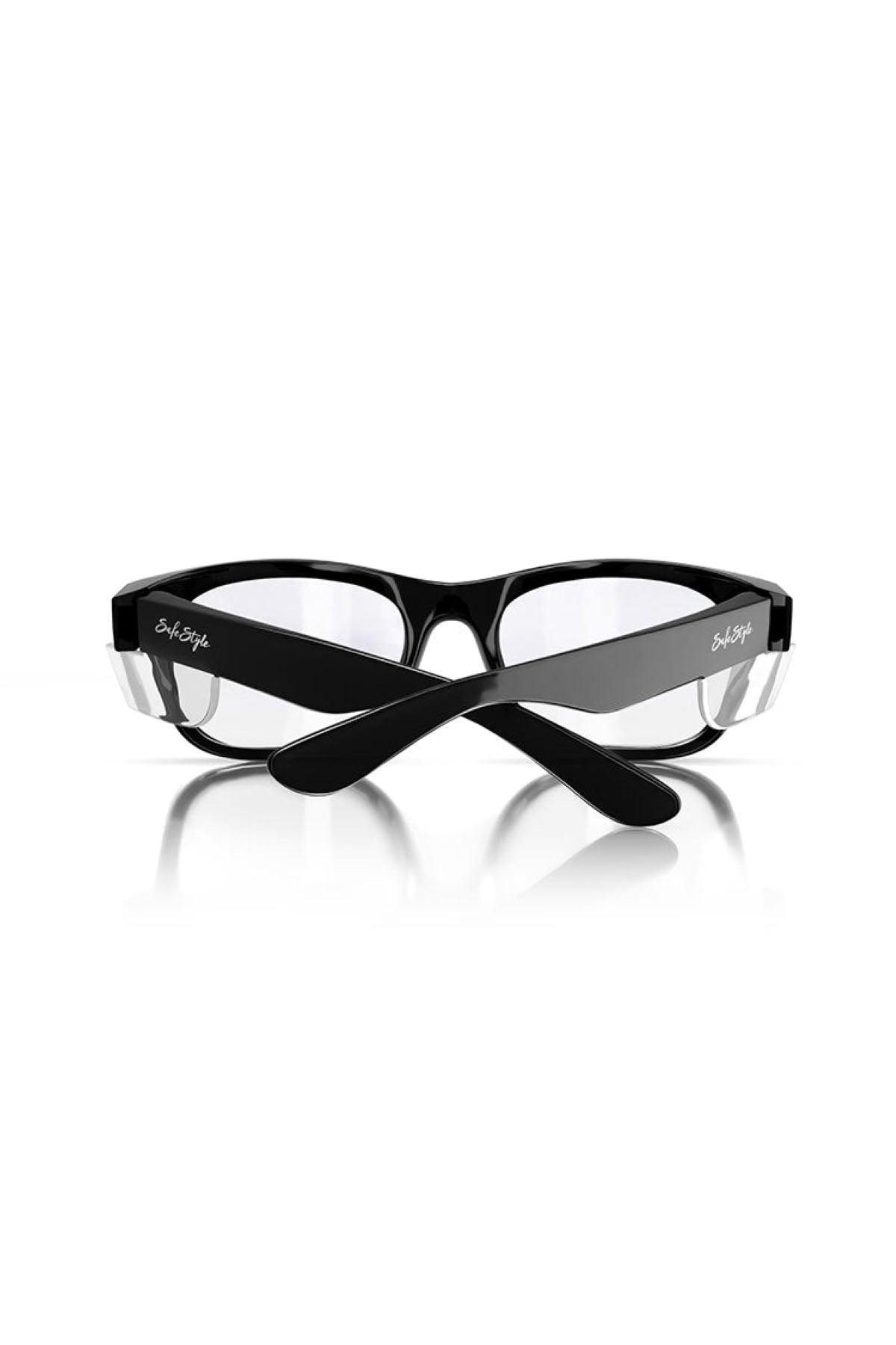 The SafeStyle Classics Black Frame Clear Lens eyeglasses are showcased against a white background. These glasses feature a sleek design with crossed temples and provide UV protection for added safety. A signature is visible on the outer sides of the temples.