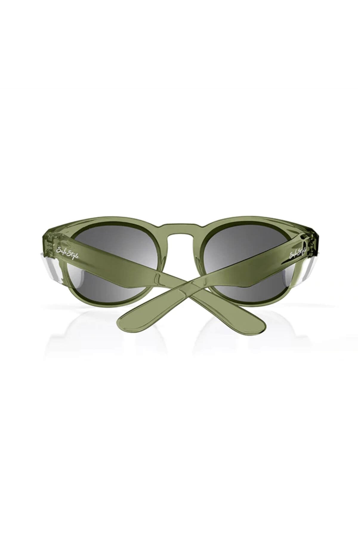SafeStyle Cruisers has glossy green, round polycarbonate frames with crossed arms and visible text. Dark polarised lenses offer UV protection. Image shows them on a white background.