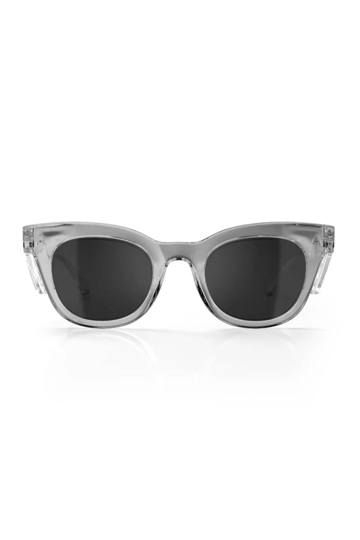 The SafeStyle Harps sunglasses feature a sleek design with transparent gray graphite frames and polarised lenses offering UV protection. These stylish sunglasses, shown on a white background, have slightly rounded lenses and shatterproof frames for enhanced durability.