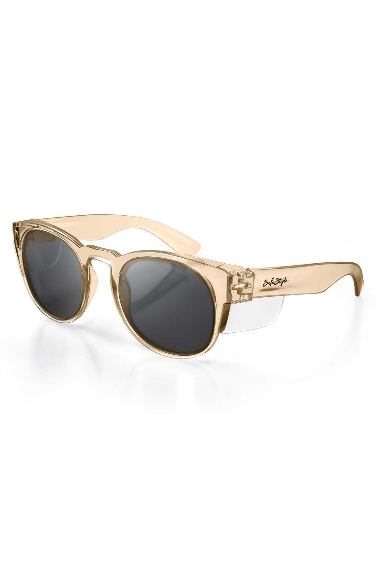 SafeStyle Cruisers Champagne Frame Tinted Lens sunglasses feature a thick beige translucent frame, dark oval polycarbonate lenses with UV400 protection, and a black logo on the left temple arm. Displayed on a white background.
