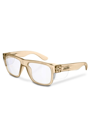 The SafeStyle Fusions Champagne Frame Clear Lens features thick, translucent beige frames with rectangular clear lenses, a logo on the left arm near the hinge, and offers UV protection for stylish, vintage-inspired eyewear.