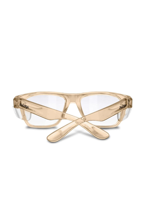 SafeStyle Fusions Champagne Frame Clear Lens safety glasses, with tan translucent frames, wide arms, and clear side shields, provide reliable UV protection. Crossed arms and front-facing eyewear are showcased on a white background.