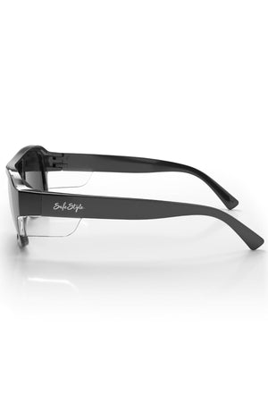 The Safestyle Skylines feature a black wraparound frame with thick arms, grey polarised lenses offering UV400 protection, and a white "SafeStyle" logo on the side. Displayed on a white background, viewed from the left.