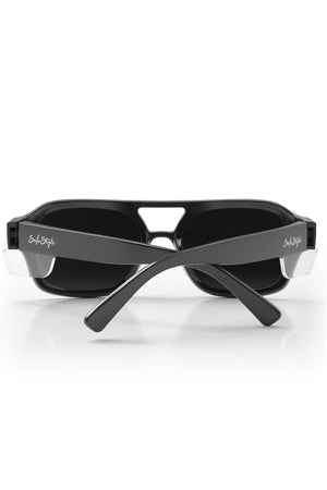 Safestyle Skylines sunglasses feature a black vintage-inspired frame with rectangular grey polarised lenses and thick crossed arms. "Sole Style" is printed in white on each temple, and they offer UV400 protection for eye safety.