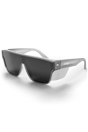 The Safestyle Primes Matte Graphite sunglasses feature a bold, angular design with a matte graphite frame, black polarised rectangular lenses, side shields for extra coverage, UV400 protection, shatterproof build, and a small logo on the temple.