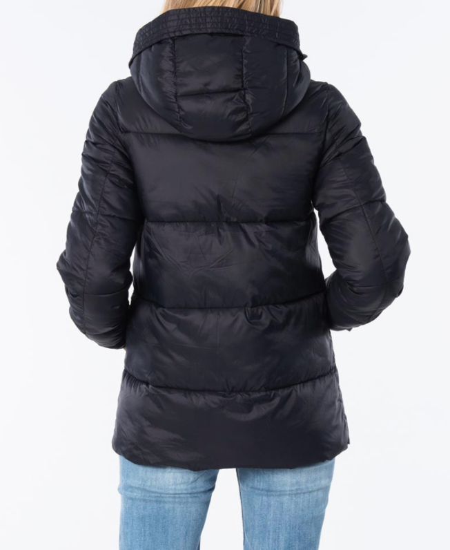 A person wearing a Rip Curl Anti Series Insulated Jacket in black, complete with a hood, is shown from the back. They are also dressed in light blue denim jeans. The durable, water-resistant coat stands out against the plain white background.