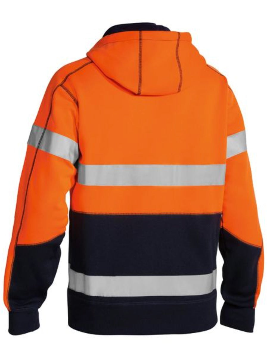 The Bisley Taped Hi Vis Fleece Hoodie With Sherpa Lining features a bright orange upper, navy blue lower, reflective taped stripes on back and sleeves, a hood, and long sleeves for added protection.