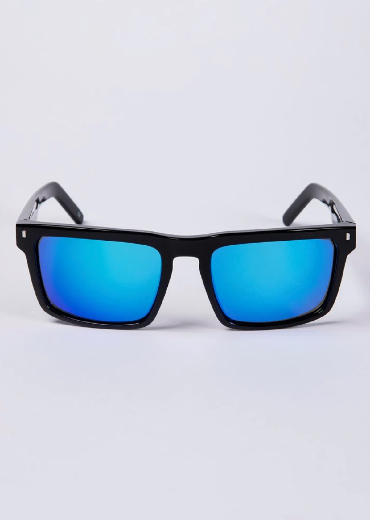 The UNIT Primer Polarised Eyewear, with black rectangular frames and reflective blue lenses, is displayed against a plain light backdrop. These lightweight sunglasses provide UV protection and are ideal for sunny adventures.