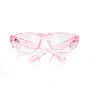 SafeStyle Fusions Pink Frame Clear Lens glasses have a stylish pink frame, clear lenses, and crossed arms. A black ribbon adorns the right side. Featuring UV400 protection, they offer excellent safety against harmful rays, all set against a white background.