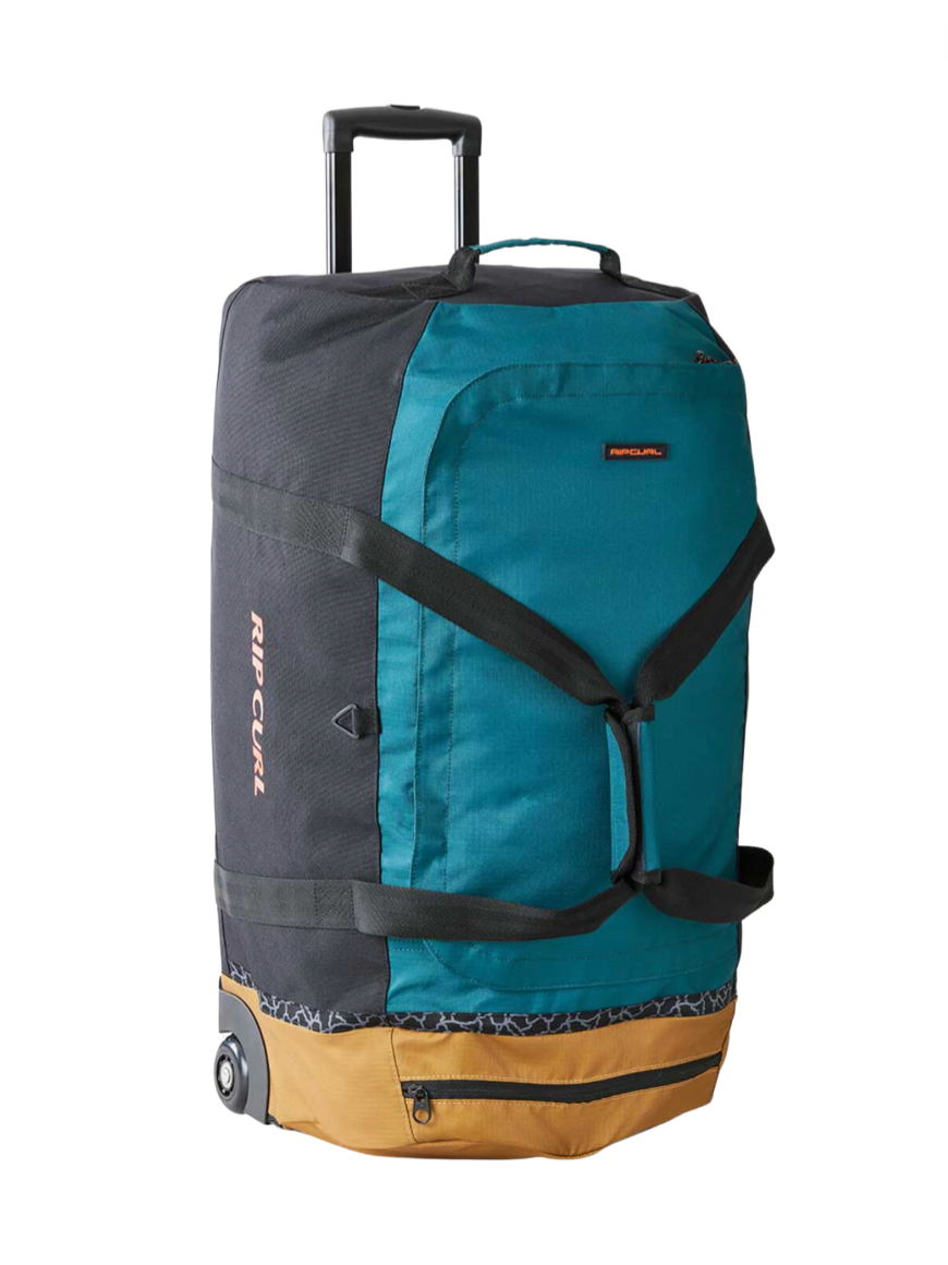 The Rip Curl Jupiter 80L Journeys Travel Bag features a teal and black design with a brown base, wheeled mobility, retractable handle, large front straps, and is made from recycled polyester. The brand name "Rip Curl" is displayed on the side.