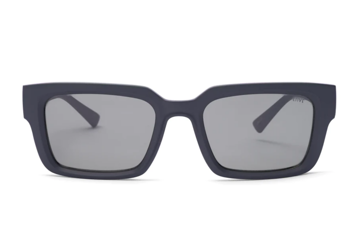 Liive Oney Sunglasses feature rectangular, matte black polycarbonate frames with thick sides and dark tinted lenses for UV protection. Displayed front-facing on a white background.