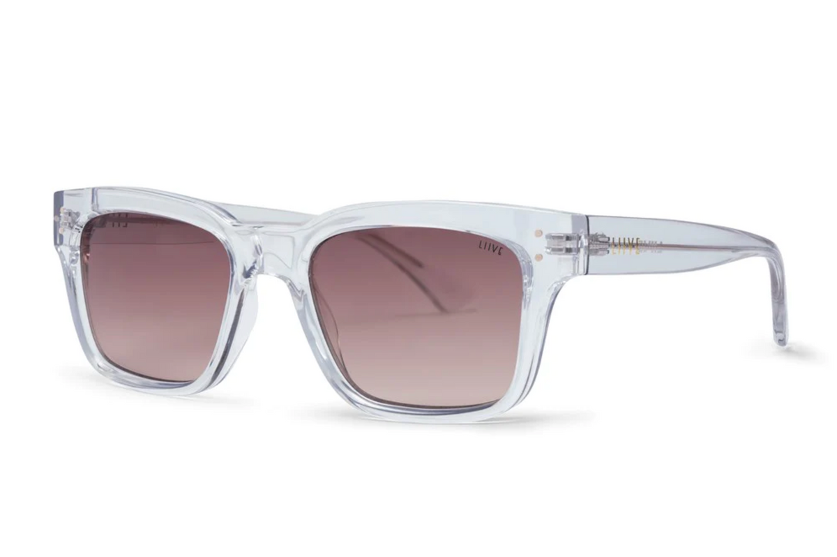 Liive Dan Sunglasses feature clear frames and square polycarbonate lenses with a light brown gradient tint, offering stylish UV protection. Displayed on a white background.