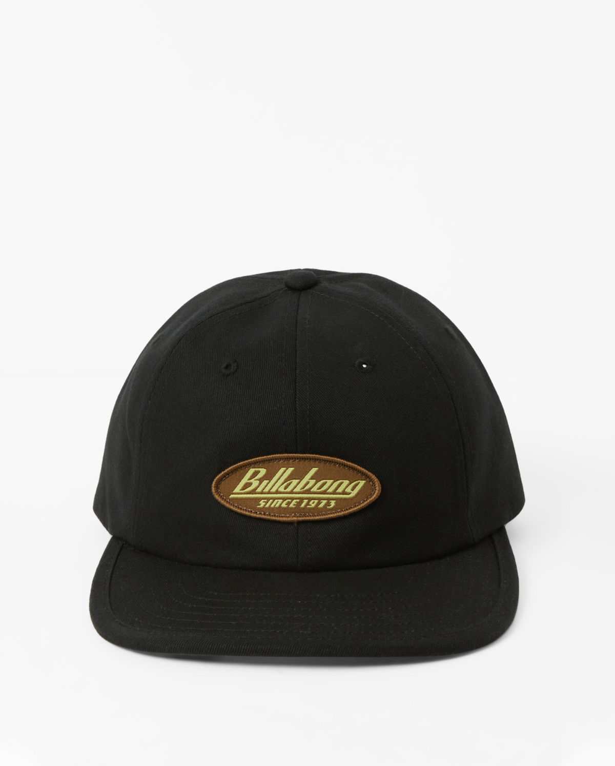 The Billabong Bong Days Strapback Cap is a sleek black design with an oval patch displaying "Billabong Since 1973" in yellow and brown. It features an adjustable webbing buckle closure for a customized fit, set against a simple white background for a timeless appearance.