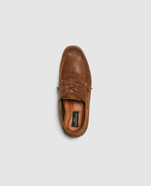 Top view of the Rodd & Gunn Gordons Bay Boat Shoe in brown leather on a light gray background. The design features a leather upper with visible stitching, lace-up detail, and a green insole with the brand label. A durable rubber outsole completes its classic look for any casual occasion.