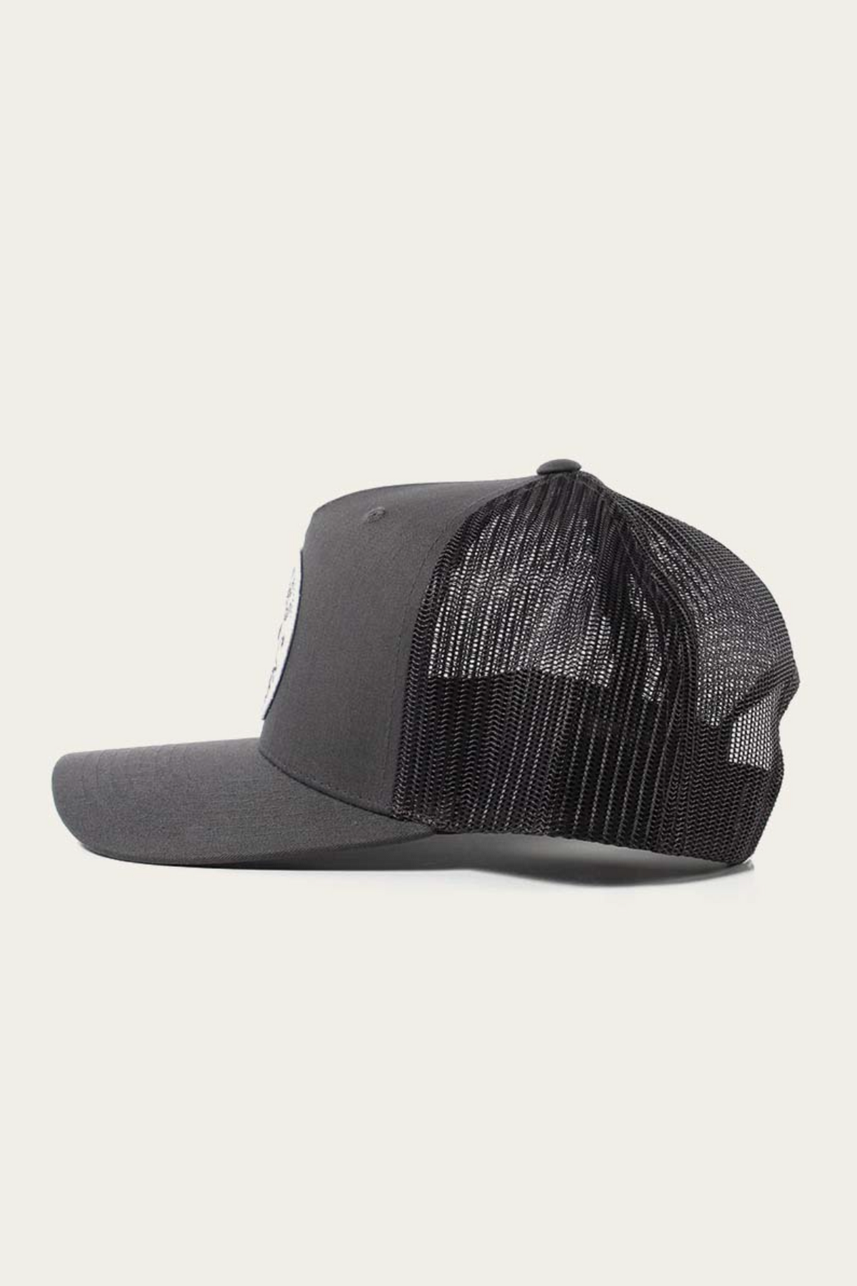 The Ringers Western Signature Bull Trucker Cap, shown from the side on a plain white background, features a black design with a mesh back and an adjustable strap.