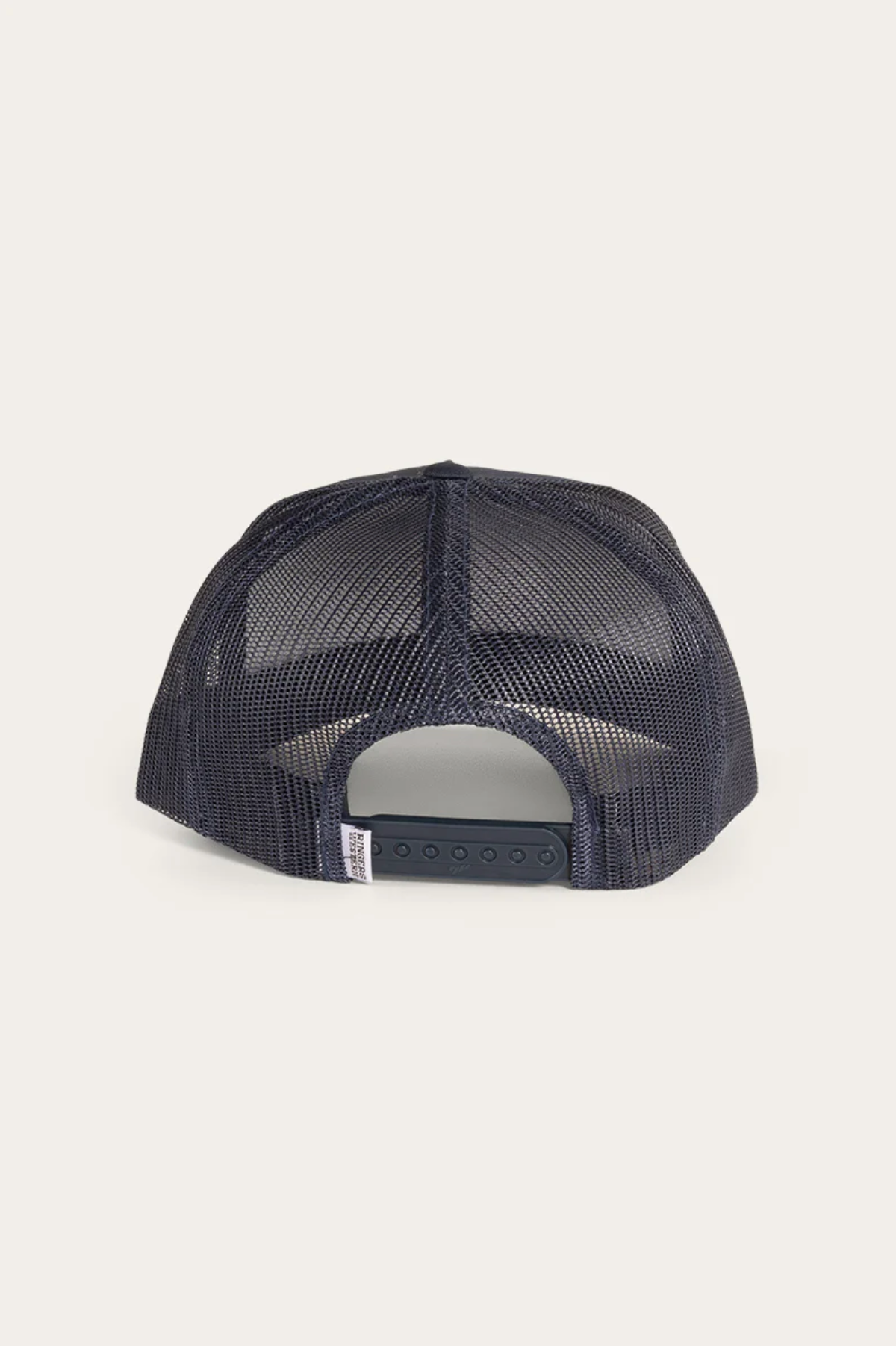 The Ringers Western Signature Bull Trucker Cap in navy is shown from the back, featuring a mesh back, adjustable snapback closure, and a small white tag on the band.