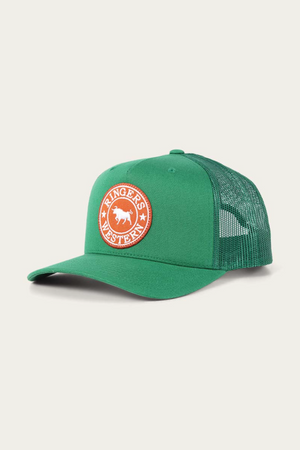 The Ringers Western Signature Bull Trucker Cap is a green cotton twill cap with a mesh back, curved brim, and features a round orange patch showcasing the "Ringers Western" logo with an image of a cow.