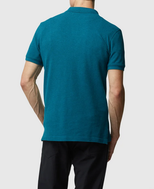 A person stands with their back to the camera, wearing a teal Rodd & Gunn "The Gunn Polo," made from Australian cotton, paired with black pants. The polo features a classic collar, all set against a plain gray background.