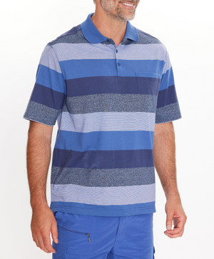 A man wearing a blue and gray striped Breakaway Neon Kinnersly Polo with a rib knit collar and blue cargo shorts stands smiling against a white background.