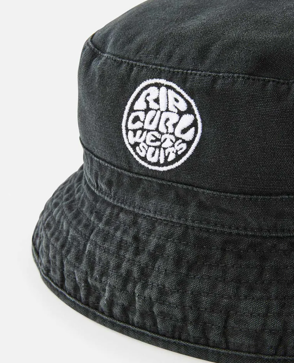 A close-up of the Rip Curl Wetsuit Icon Mid Brim Hat, showcasing its white circular embroidered "RIP CURL WETSUIT" patch on the front, with detailed texture and stitching visible.