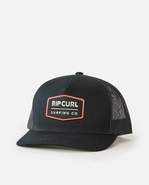 The Rip Curl Marker Curve Trucker hat is black with a mesh back and features a front patch reading "Rip Curl Surfing Co" in white on dark, outlined in red. The embroidered logo pops against the plain white background.