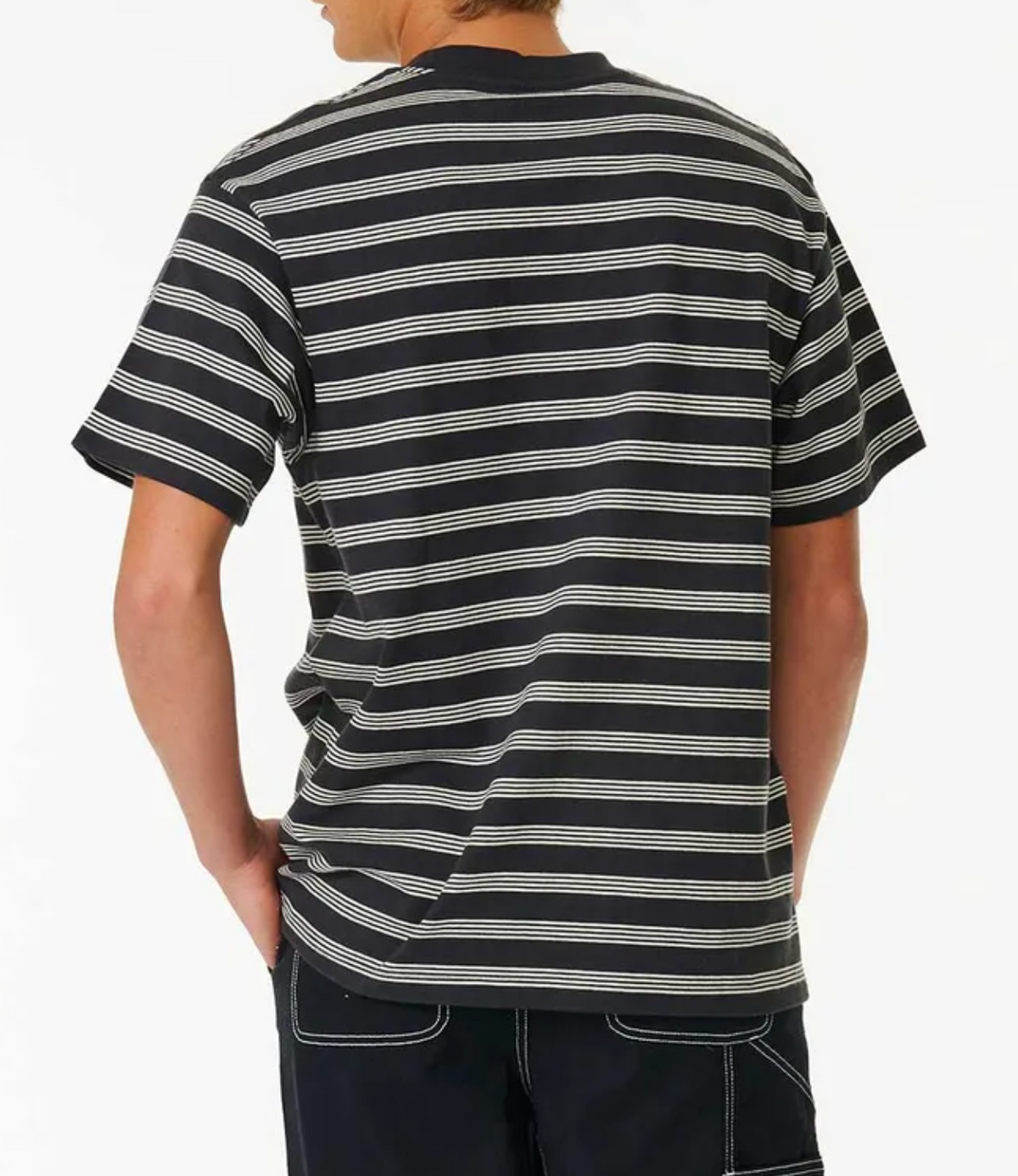 A person faces away from the camera wearing the Rip Curl Quality Surf Products Stripe Tee with white stripes and dark pants, set against a plain white background—ideal for fans of surf style and casual comfort.