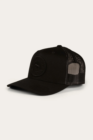 The Ringers Western Signature Bull Trucker Cap is a black cotton twill hat with a curved brim, mesh back, and circular patch logo on the front, shown against a plain light background.