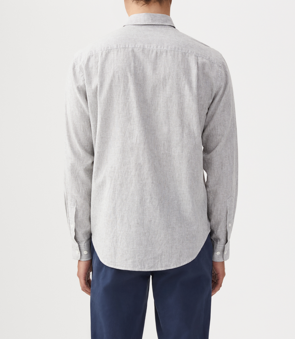 The person is wearing a light gray long-sleeve RM Williams Coalcliff Shirt and dark navy pants, viewed from the back against a plain white background.