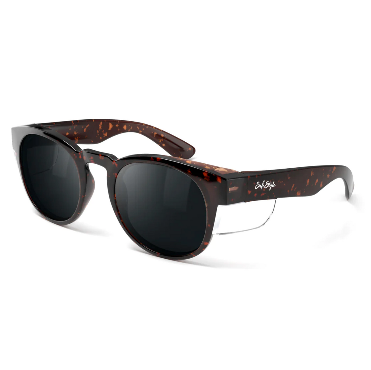 The SafeStyle Cruisers Brown Tort Frame Polarised Lens features round polycarbonate frames with a speckled brown and black tortoiseshell pattern, dark polarised lenses, silver accents, and a white signature logo on the left arm.