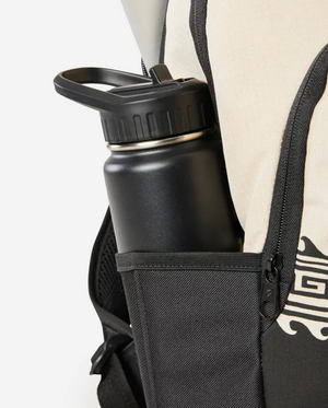 Close-up of a sleek black water bottle in the side pocket of the Rip Curl Ozone 2.0 30L Backpack, featuring a stylish black and beige geometric pattern. It includes a laptop section and uses sustainable materials like recycled polyester for thoughtful design.