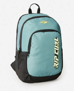 The Rip Curl Ozone 2025 School 30L Backpack in teal and black is made from recycled polyester, has two zippered compartments, side pockets, a yellow and white front logo, a top handle, and black shoulder straps—perfect for school use.