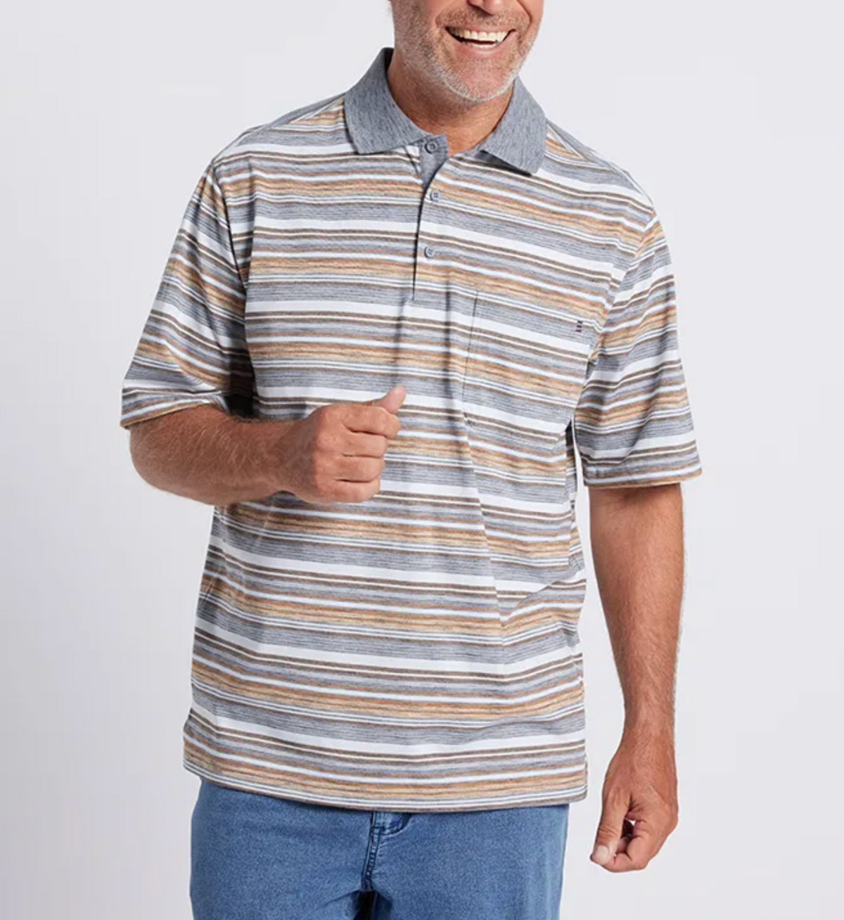 A man smiles wearing the Breakaway Yoli Kinnersly Polo—a short-sleeve shirt with gray, yellow, and white stripes. He has a neatly trimmed beard, blue jeans, and his right hand is slightly raised.