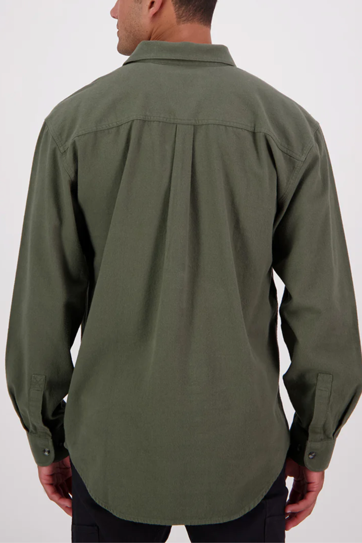 A man is shown from the back, standing against a plain light background, wearing a relaxed fit Swanndri Barn Shirt in olive green made from 100% cotton.
