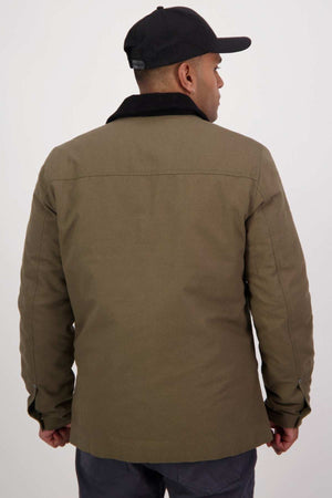 A person in a Swanndri Barrytown v3 Canvas Work Jacket and a black cap is facing away from the camera. The quilted insulated jacket, featuring a dark collar and buttoned cuffs, stands out against a plain white background.