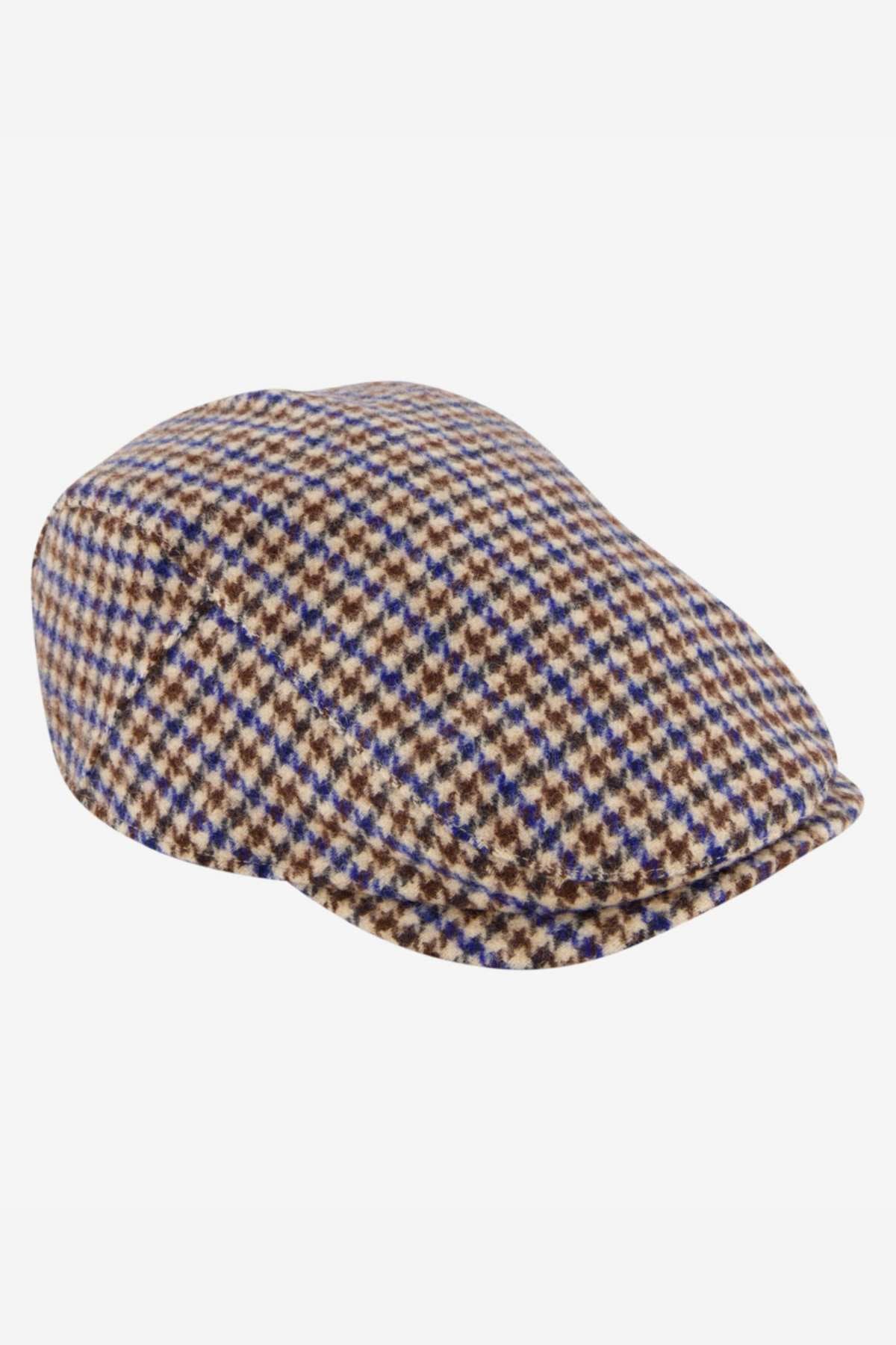 The Swanndri Bristol Flat Cap is a wool blend featuring a brown, beige, and blue houndstooth pattern—an ideal outdoor accessory with timeless style.