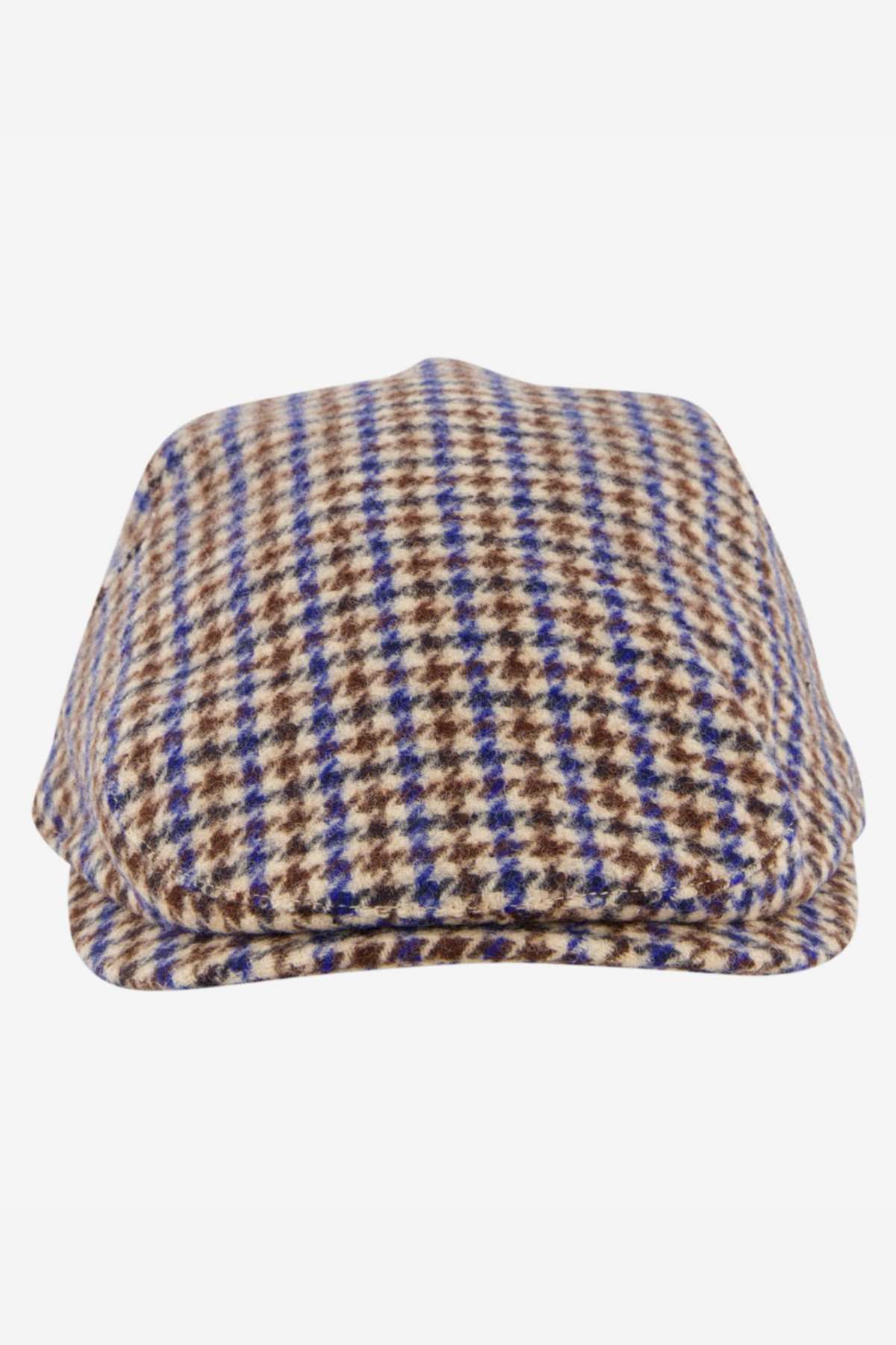 The Swanndri Bristol Flat Cap showcases a classic houndstooth pattern in brown, beige, and blue tones. Made from a quality wool blend, this cap is an ideal outdoor accessory and is displayed against a white background.