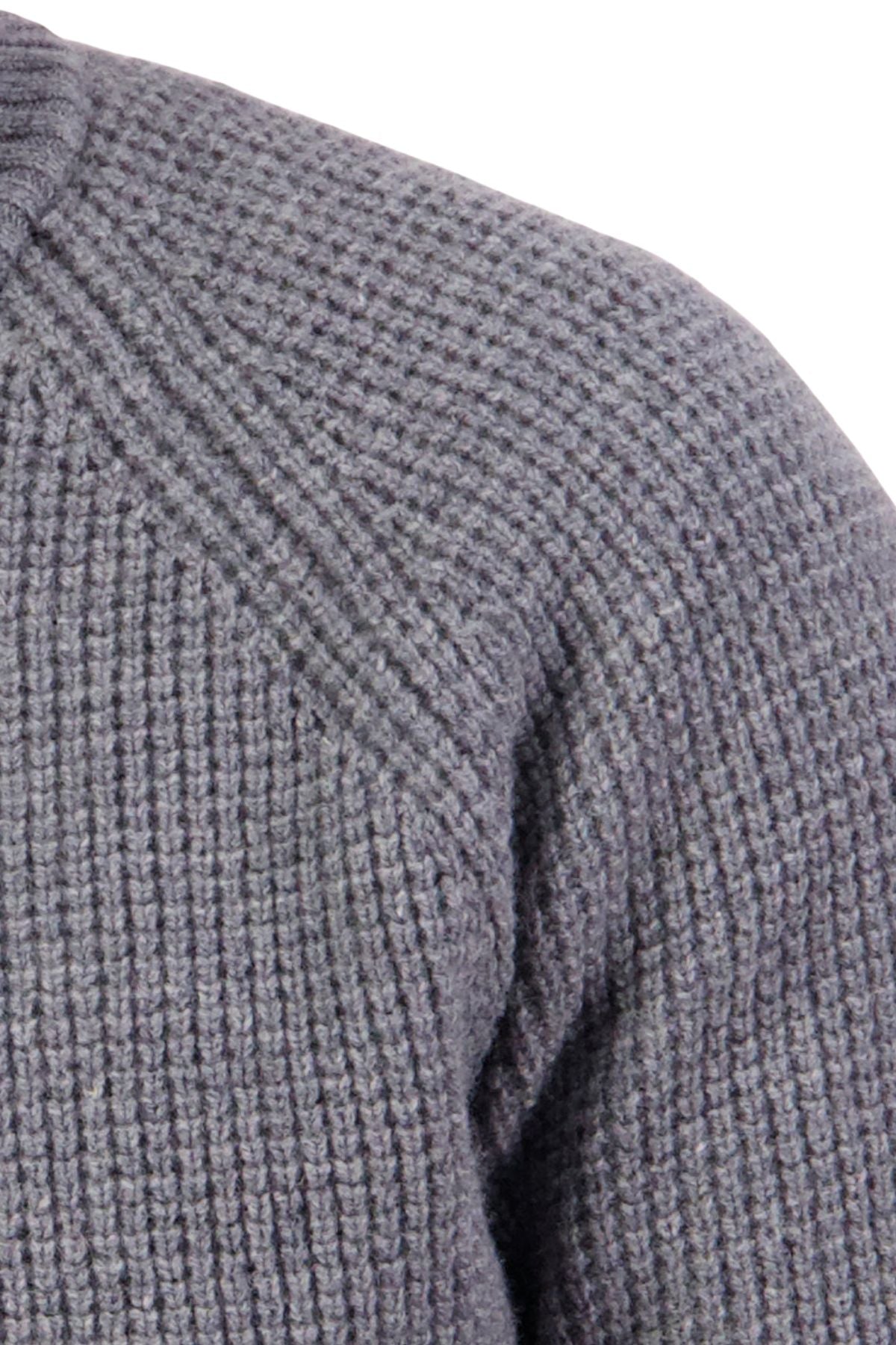 Close-up of the Swanndri Chalky Island Waffle Jumper in gray lambswool, showcasing its textured waffle knit pattern and shoulder seam detail against a white background.